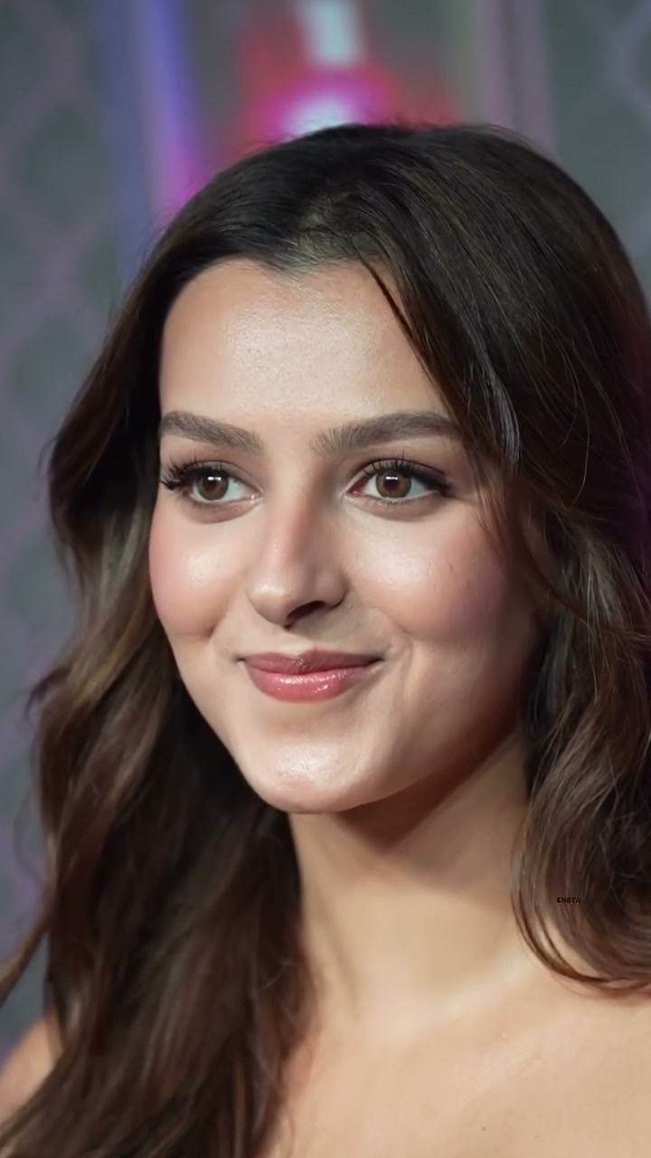 Close-up portrait of actress Triptii Dimri with soft wavy dark brown hair, gentle subtle smile at...
