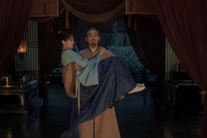 Bearded man in traditional hanfu carries a young woman through a dim ancient Chinese palace chamber