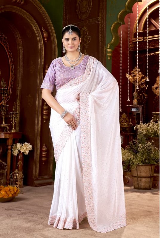 Model posing in elegant embroidered white saree with lavender blouse and diamond jewelry in ornat...