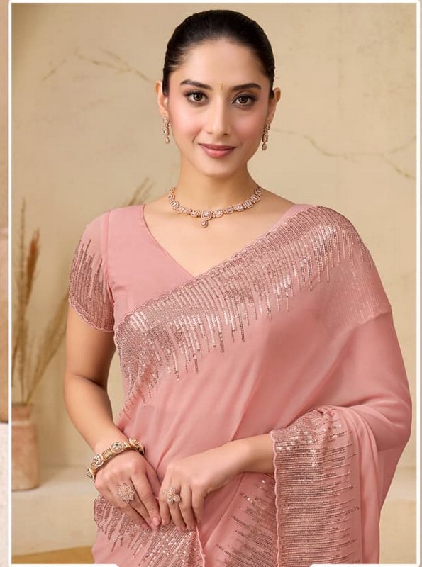 Portrait of South Asian woman wearing an elegant dusty pink sequin saree and rose gold kundan jew...