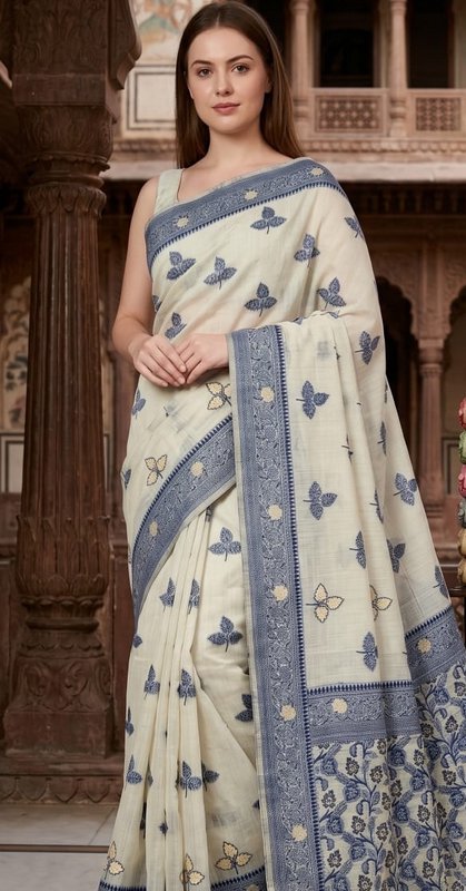 Model wearing elegant ivory embroidered saree with blue butterfly and floral details, posed again...