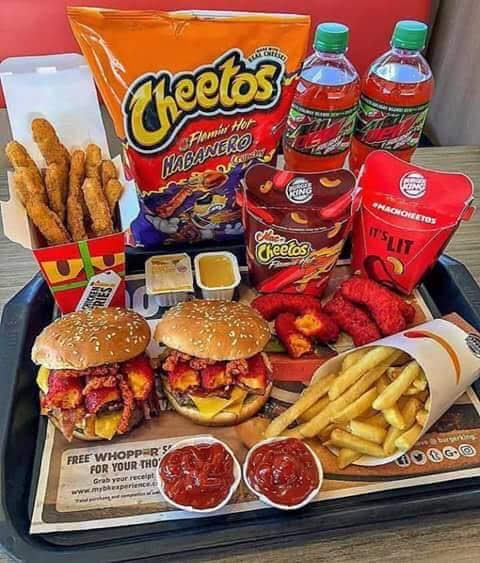 Loaded fast food tray of Burger King x Cheetos spicy menu items, burgers, fries, chicken, soda an...