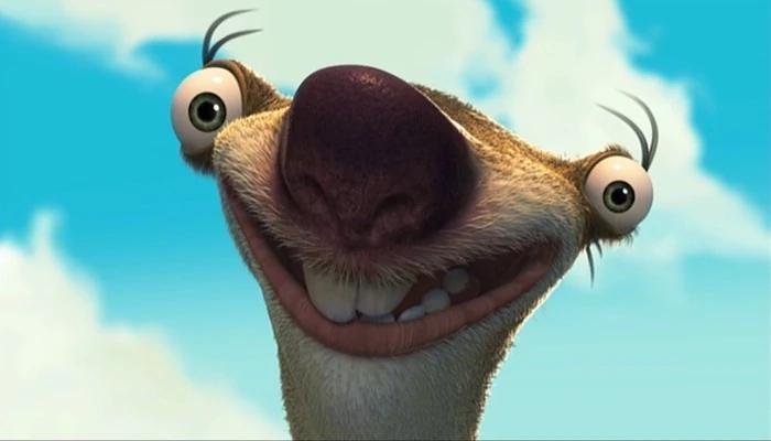 Close up goofy portrait of Sid the Sloth from Ice Age against bright blue cloudy sky