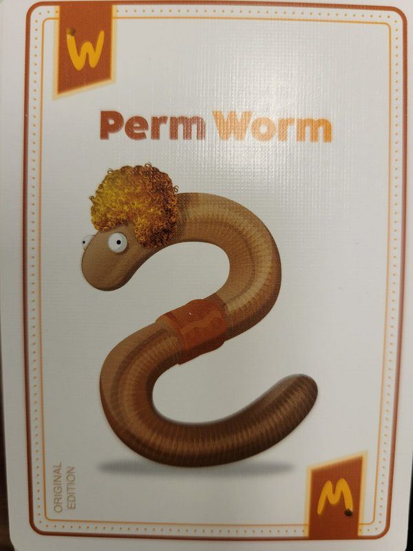 Illustrated game card of the silly Perm Worm character, a cartoon earthworm with a curly golden b...