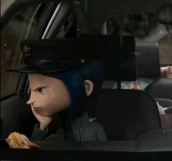 Edited Coraline puppet meme of grumpy taxi driver resting chin on hand inside a dim car