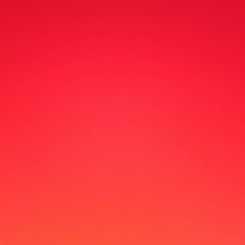 Smooth vertical gradient transitioning from rich crimson red at top to warm tangerine orange at b...
