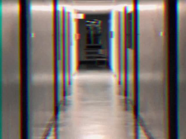 Glitch effect shot of empty institutional hallway with vertical RGB chromatic aberration distorti...