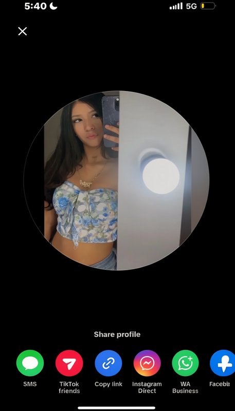 Mobile share profile screen showing a circular preview of a young woman taking a mirror selfie