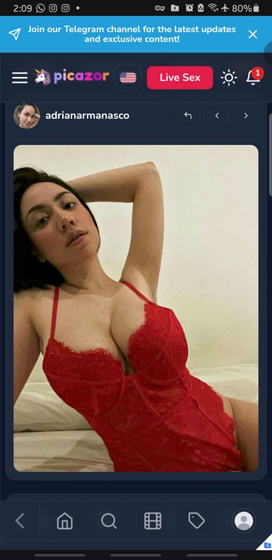 Screenshot of social media post showing a woman in red lace lingerie posing reclined on a bed, di...