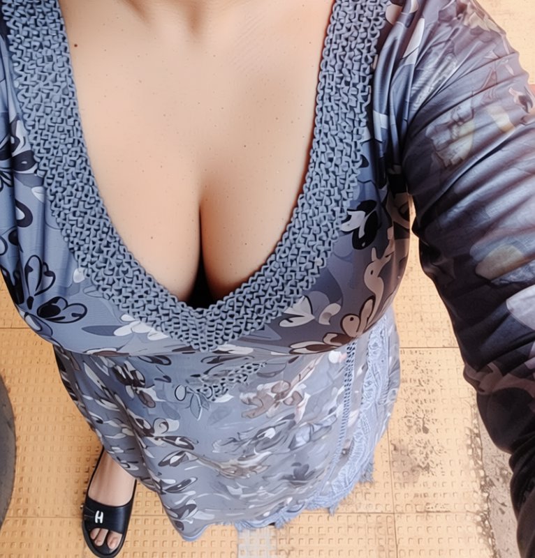Overhead first-person view of a woman wearing a grey floral lace-trimmed loungewear dress and bla...
