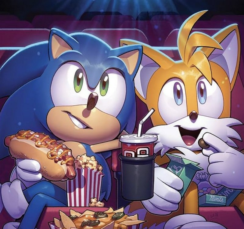 Sonic the Hedgehog and Tails hold movie snacks while sitting in theater seats watching a film, ca...