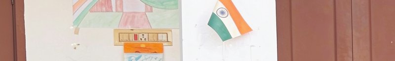 Hand-drawn Indian national flag illustration sits beside colorful student artwork on a white clas...