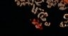Heavily blurred close-up of curly light brown hair and a hand with red nail polish against a soli...