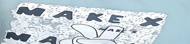 Close up partial view of a textured MAKEX sticker with a cartoon bunny graphic on pale blue backg...