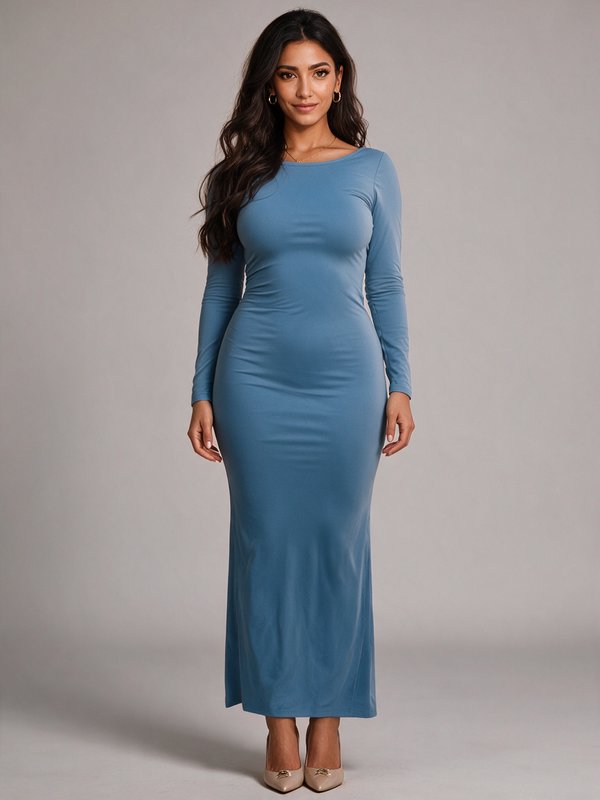 Fashion model wearing a form-fitting slate blue long sleeve maxi dress in a studio portrait.