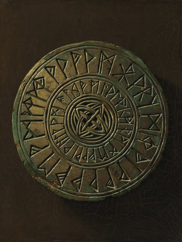 Patinated bronze runic disc carved with Norse symbols and knotwork, displayed against a dark crac...