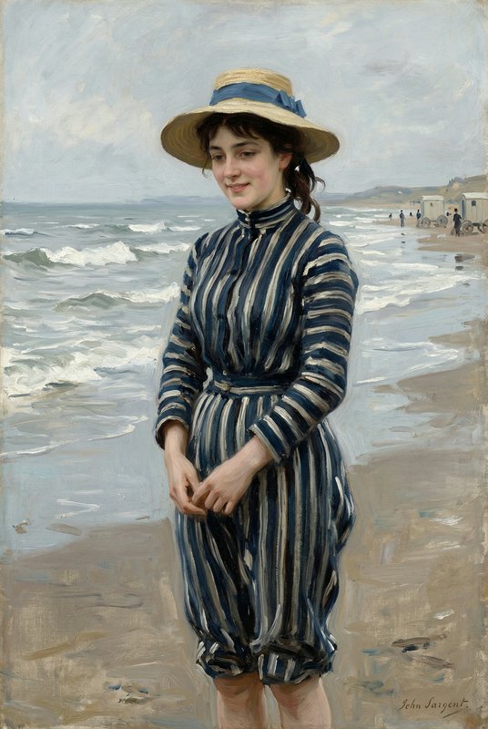 Portrait of a woman in a blue-striped dress on a beach, wearing a straw hat.