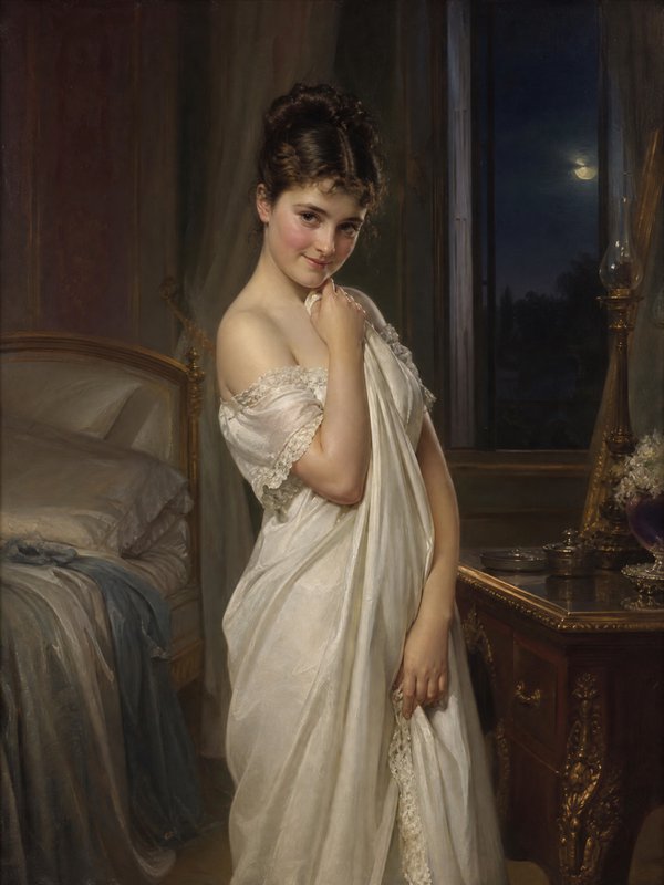 Portrait of a young woman in a white satin gown standing beside a bed in a luxurious bedroom.