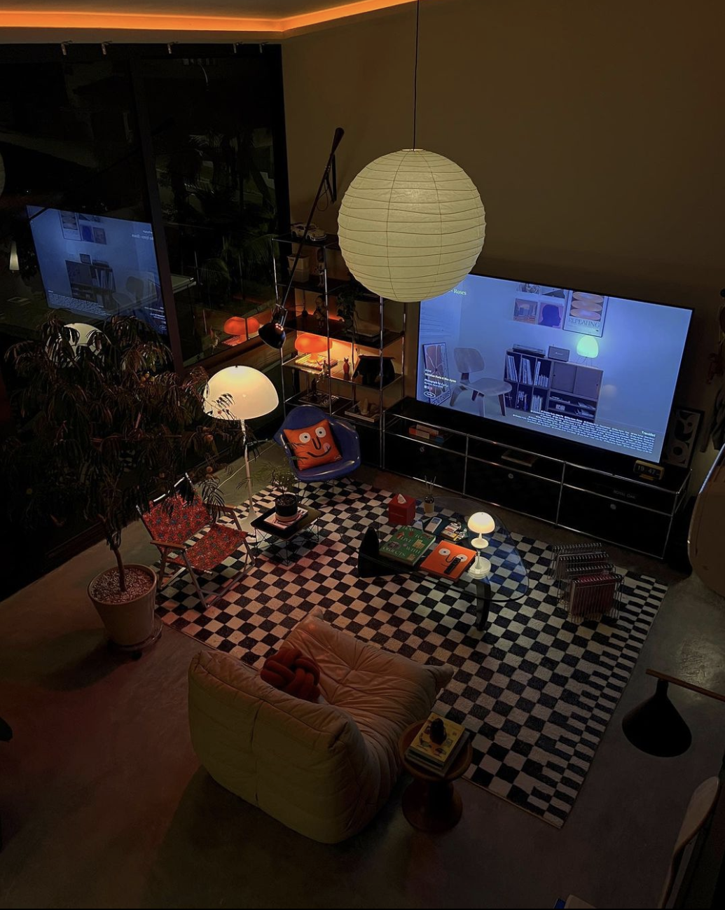 High angle view of a dim cozy retro living room with checkered rug, paper pendant light, and matching smiley decor