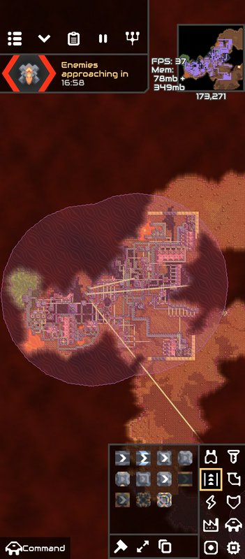 Top-down Mindustry gameplay screenshot showing a player base, incoming enemy wave timer, and game...