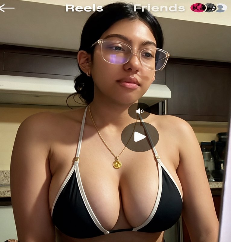 Screenshot of Instagram Reel featuring young woman with clear glasses in a black bikini top stand...