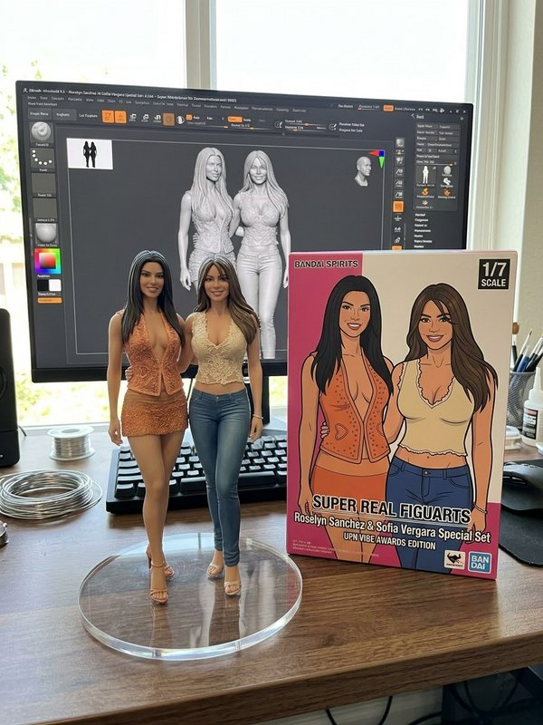 Custom 1/7 scale Sofia Vergara and Roselyn Sanchez figurines displayed with their product box and 3D sculpt on a creator desk