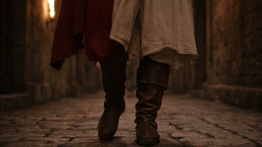 Close-up of boots walking on cobblestone alley with warm, dim lighting.