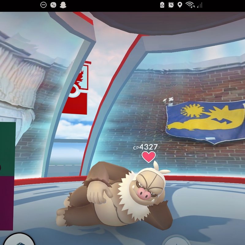 Screenshot of CP 4327 Slaking resting inside a frosty Pokémon Go gym with a love heart status icon.