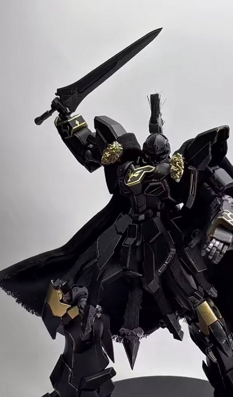 Custom black armored knight mecha model with gold accents, fabric cape, and raised sword, Gundam-...