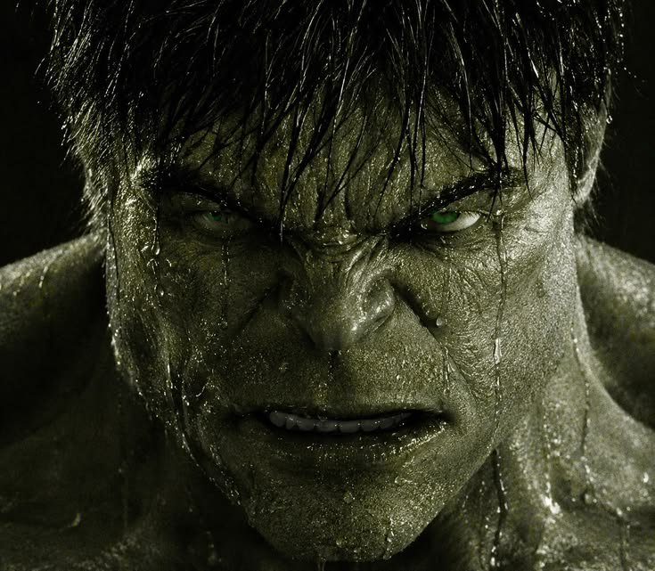 Close-up portrait of angry glistening green Hulk, with intense bright green eyes, snarling direct...