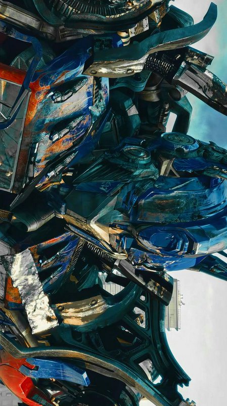 Close-up of battle-worn Optimus Prime, the iconic blue and orange Transformers Autobot, against a...