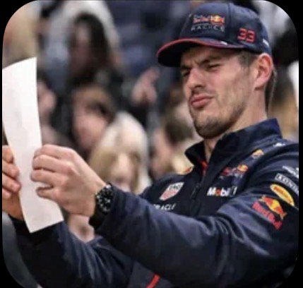 Max Verstappen squints skeptically while holding and reading a sheet of paper in his Red Bull F1 ...