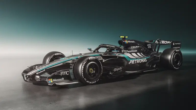 Side profile studio shot of the matte black Mercedes Petronas Formula 1 race car with official sp...