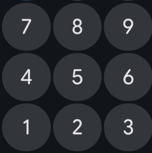 Close up of a dark mode smartphone passcode keypad with 3x3 grid of numbered buttons 1 through 9