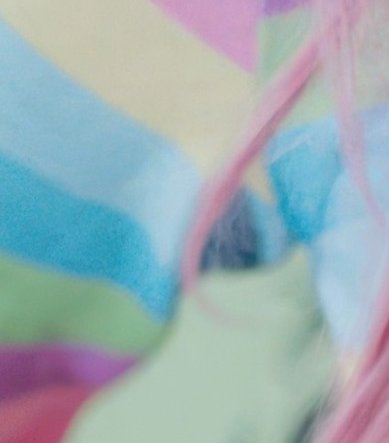 Blurred close-up of soft folded pastel rainbow fabric, with wavy muted pink, blue, yellow, green,...