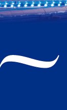 Curved white swimming pool lane marker on deep blue competition pool, overhead arena lights visib...