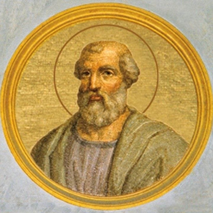 Circular mosaic portrait of a bearded Christian saint with halo, set in a gilded oval frame again...