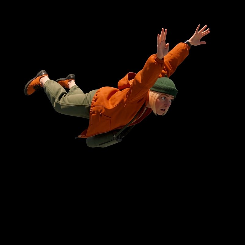 Startled young woman free falls with outstretched arms against a solid black background