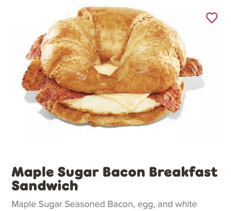 Flaky golden croissant maple sugar bacon egg cheese breakfast sandwich menu listing on white back...