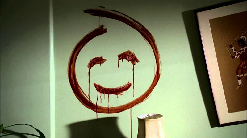 Iconic dripping red blood smiley face, the Dexter series signature, painted on a light green inte...