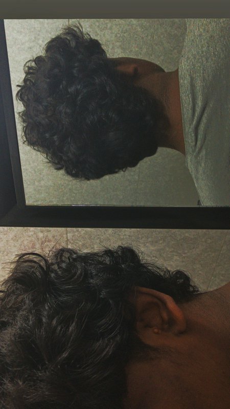 Stacked side-by-side comparison: top mirror reflection of dark curly hair, bottom real-life close...