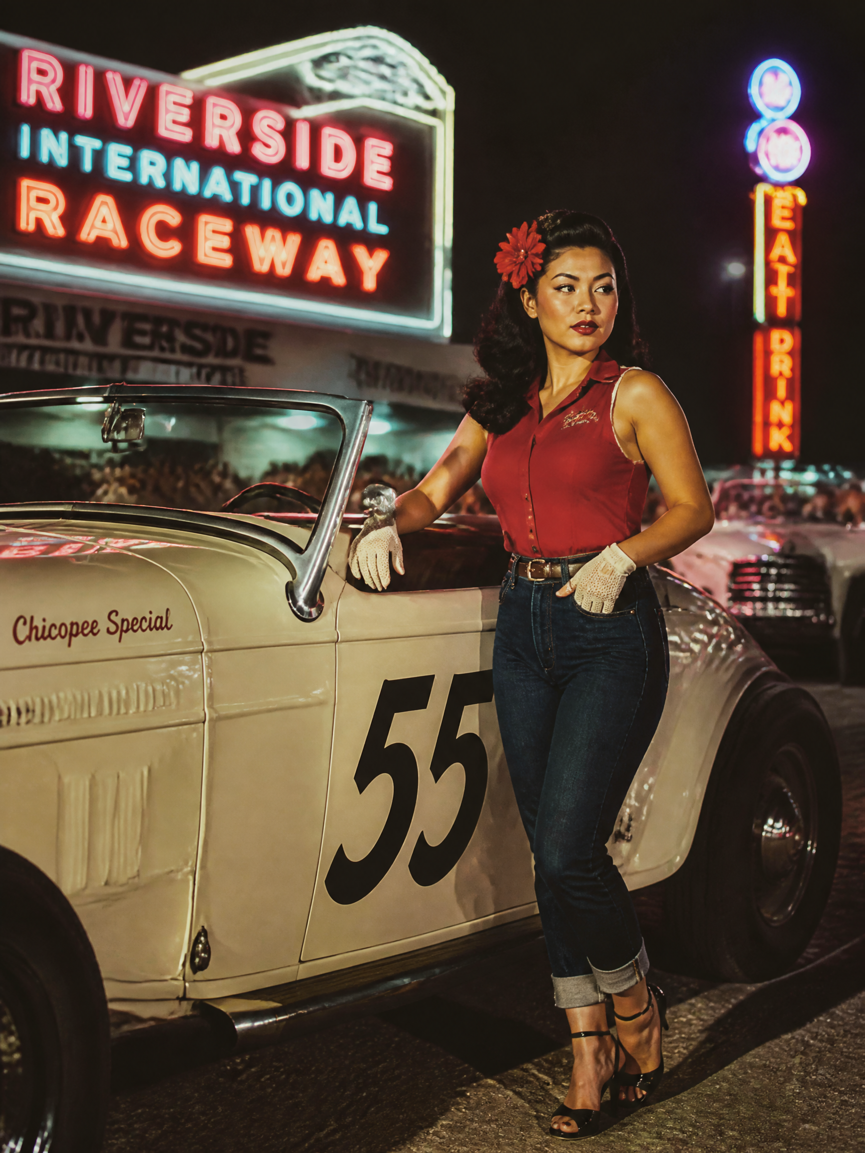 Pin-up model in a red sleeveless top and jeans leaning on a vintage white race car at a neon-lit 1950s racetrack.
