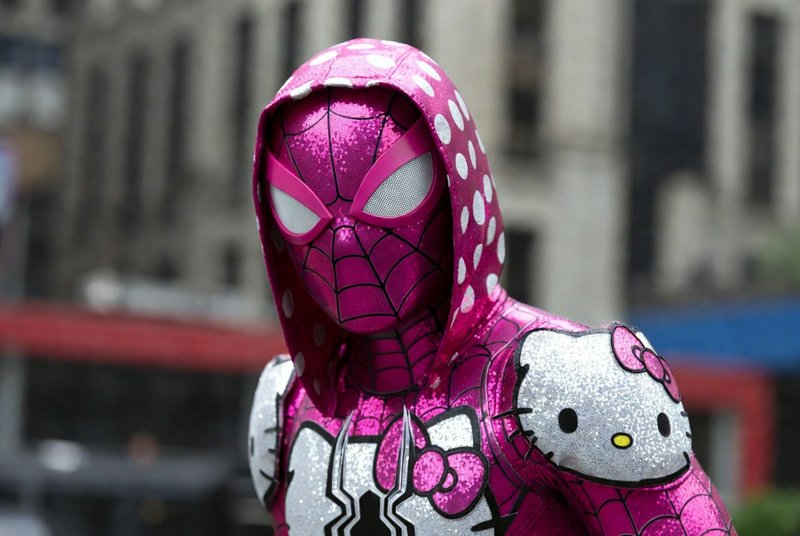Person in a shiny pink Spider-Man-style costume with a polka-dotted hood and Hello Kitty graphics.