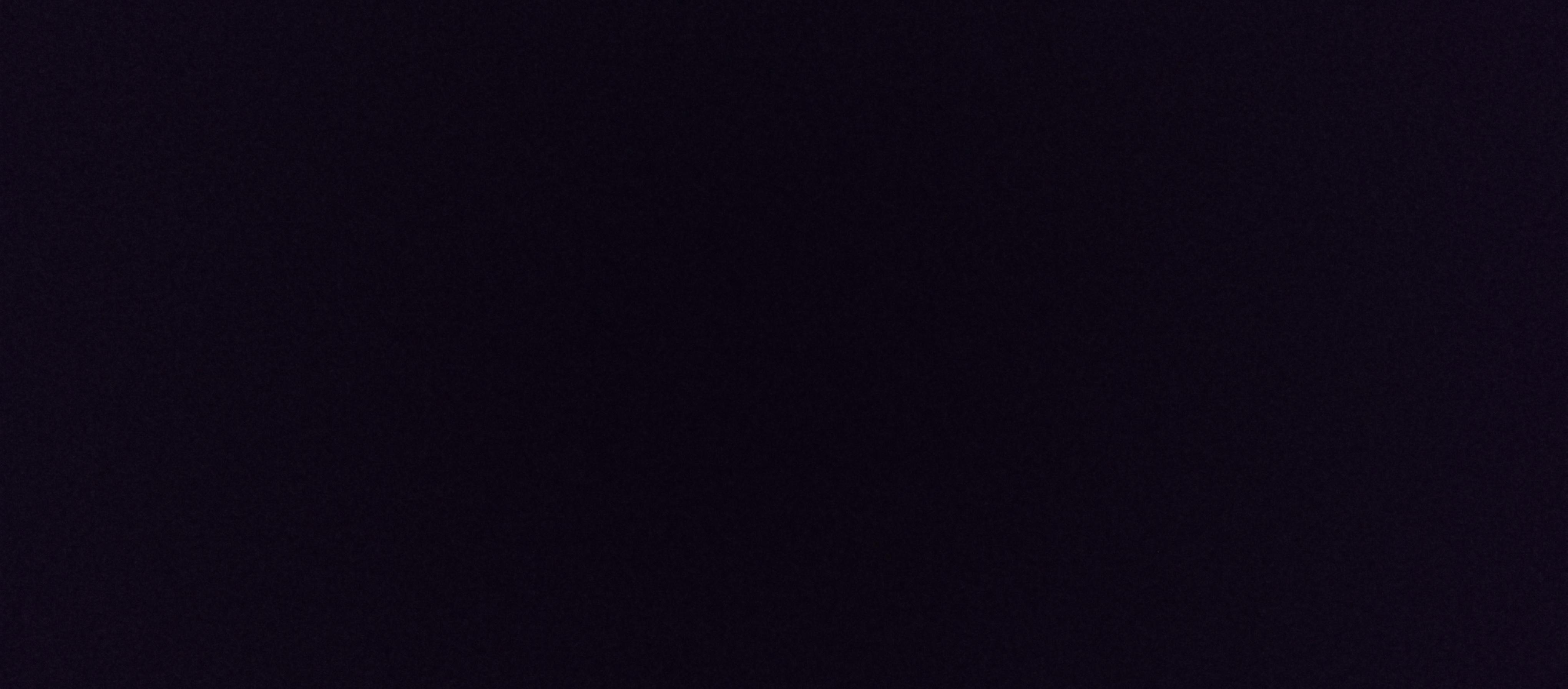 Subtly grainy deep near-black dark purple solid blank background