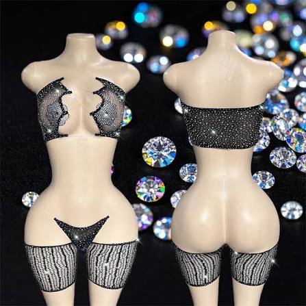 Front and back view torso mannequins display a sparkly black rhinestone lingerie set against a scattered gem backdrop