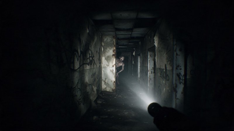 Glowing-eyed humanoid monster peeks around a hallway corner in an abandoned building lit by flashlight