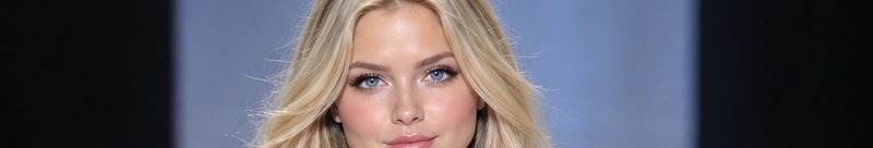 Close-up portrait of a blonde woman with bright blue eyes looking directly at the viewer