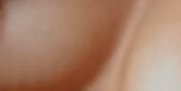 Close-up of warm-toned human skin texture with soft lighting.
