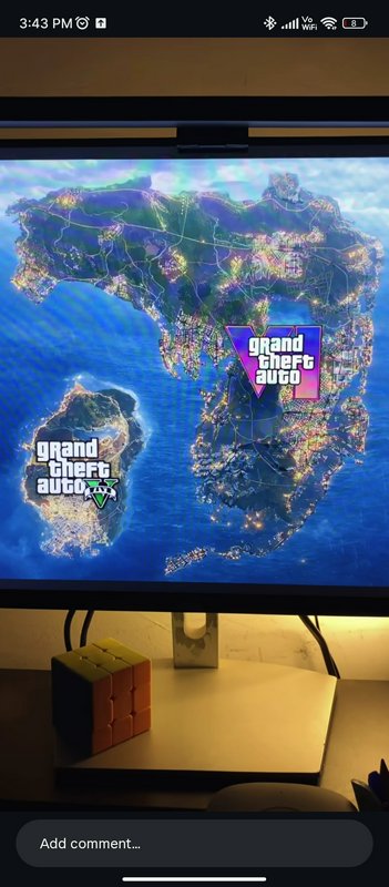 Screenshot of a monitor displaying the Grand Theft Auto V map with two GTA V logos.