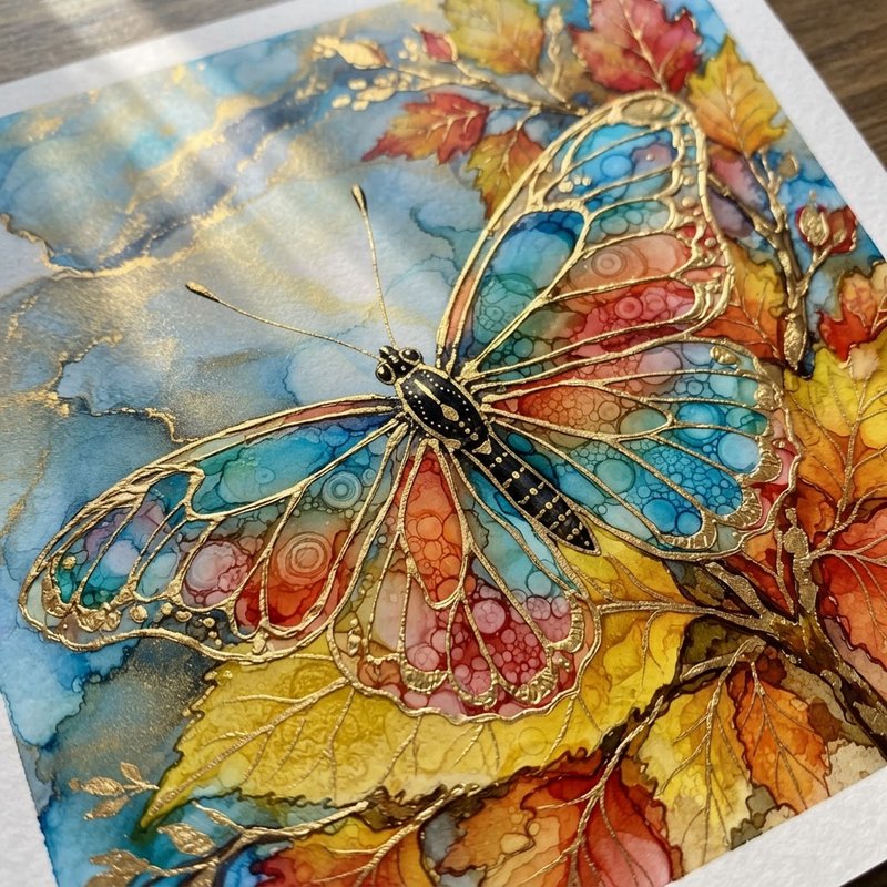 Ornate gold-outlined stained-glass style butterfly artwork with autumn leaves, swirled blue alcoh...